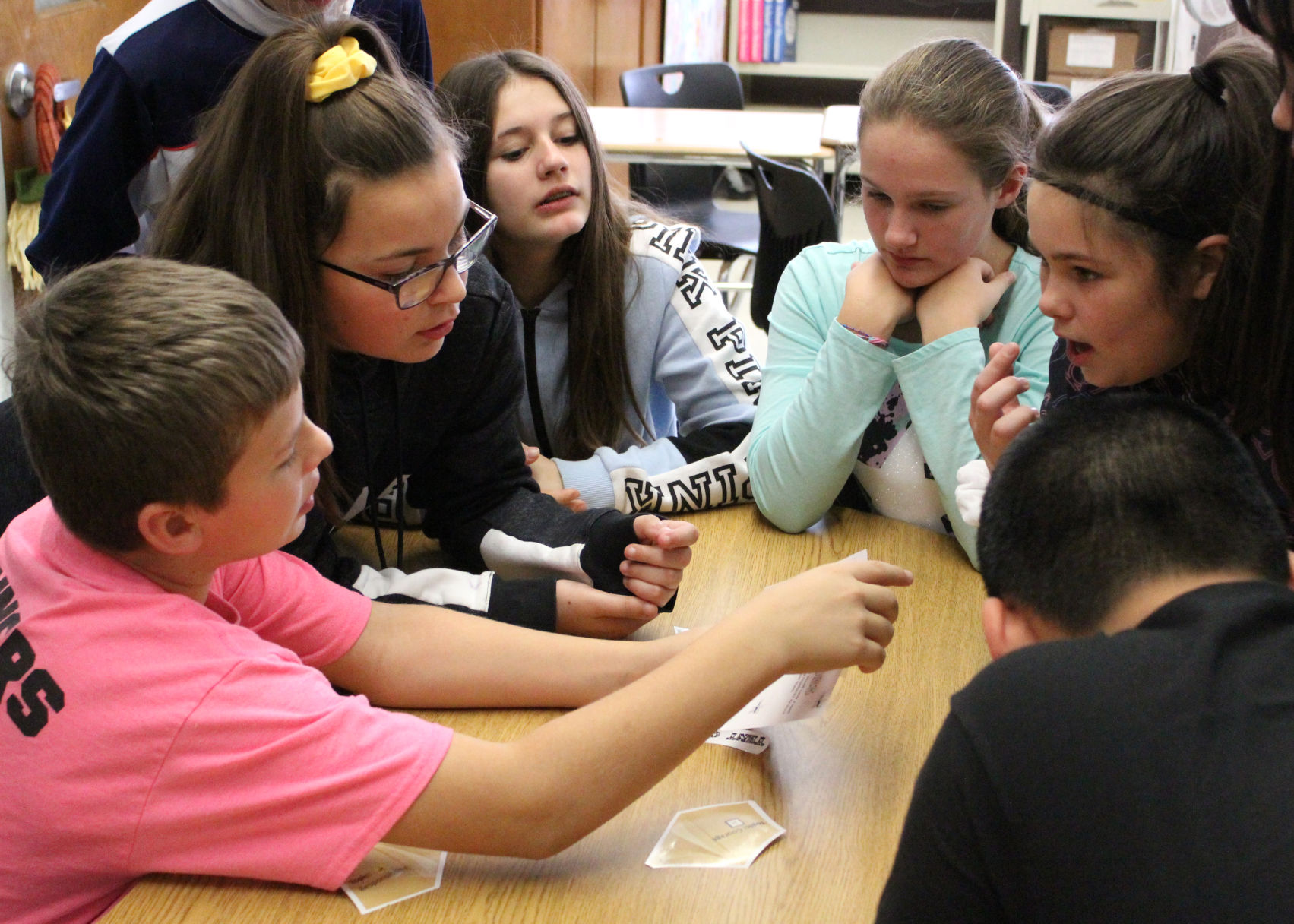 Students collected clues and puzzle pieces to find combinations to open the locked box..jpg